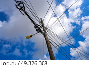 Messy electric aerial wires and pole in Mexico. Стоковое фото, агентство Ingram Publishing / Фотобанк Лори