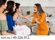 Three women have arrived for birthday celebration and presenting gift to birthday woman. Стоковое фото, фотограф Яков Филимонов / Фотобанк Лори