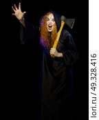 Scary young witch isolated on black. Стоковое фото, агентство Ingram Publishing / Фотобанк Лори