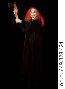 Scary young witch isolated on black. Стоковое фото, агентство Ingram Publishing / Фотобанк Лори