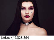 Halloween Vampire Woman portrait. Beautiful Glamour Fashion Sexy Vampire Lady with long dark Hair, beauty make up and Costume. Стоковое фото, агентство Ingram Publishing / Фотобанк Лори