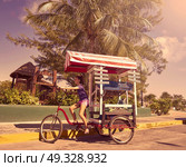 Young girl with caribbean bicycle shop on tricycle of Mexico. Стоковое фото, агентство Ingram Publishing / Фотобанк Лори