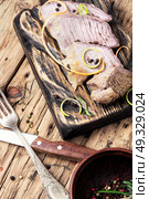 sliced baked beef meat on a kitchen cutting board. schnitzel on kitchen cutting board. Стоковое фото, агентство Ingram Publishing / Фотобанк Лори