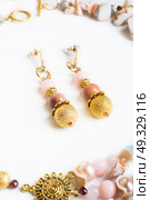 gold handmade earrings with pink semipreciouses. nephritis and variscite. Стоковое фото, агентство Ingram Publishing / Фотобанк Лори