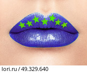 Close up view of Beautiful Woman Lips with Purple Lipstick.  Cosmetology, drugstore or Fashion Makeup Concept Gold stars. Beauty studio shot. Passionate Kiss. Стоковое фото, агентство Ingram Publishing / Фотобанк Лори