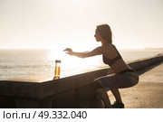 Fitness woman doing exercices on summer sunset. Стоковое фото, агентство Ingram Publishing / Фотобанк Лори