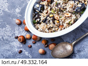 rice with mushrooms. traditional risotto from rice and mushrooms in an oval dish. Стоковое фото, агентство Ingram Publishing / Фотобанк Лори