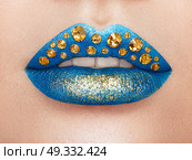 Close up view of Beautiful Woman Lips with blue Lipstick. Open Mouth with white Teeth. Cosmetology, drugstore or Fashion Makeup Concept.  Beauty studio shot. Passionate Kiss. Стоковое фото, агентство Ingram Publishing / Фотобанк Лори