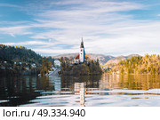 Lake Bled in the Alpine mountains in autumn under blue sky. Стоковое фото, агентство Ingram Publishing / Фотобанк Лори