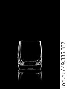 transparent glass for brandy or cognac on black background with reflection. Стоковое фото, агентство Ingram Publishing / Фотобанк Лори