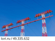 supports of high-voltage power lines against the blue sky. Стоковое фото, агентство Ingram Publishing / Фотобанк Лори