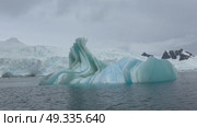 Big Iceberg in Antarctica Winter Scenery, Amazing Shape Ice Formation of Massive Large Enormous Blue Icebergs in Antarctic Peninsula Landscape Seascape with Ocean Sea Water. Стоковое видео, видеограф Vladimir / Фотобанк Лори