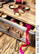 Thread spools and buttons. Wooden retro cupboard ,with thread spools and buttons. Sewing accessories. Стоковое фото, агентство Ingram Publishing / Фотобанк Лори