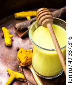 Turmeric Golden milk. Turmeric Golden milk in a glass cup. Стоковое фото, агентство Ingram Publishing / Фотобанк Лори