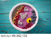 Acai bowl smoothie pitaya hearts blueberry goji chia pomegranate and seeds for Valentines day. Стоковое фото, агентство Ingram Publishing / Фотобанк Лори