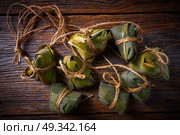 Zongzi Glutinous sticky Rice Dumplings recipe wrap with bamboo leaves asian food. Стоковое фото, агентство Ingram Publishing / Фотобанк Лори