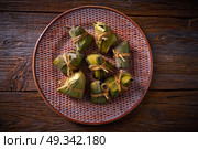 Zongzi Glutinous sticky Rice Dumplings recipe wrap with bamboo leaves asian food. Стоковое фото, агентство Ingram Publishing / Фотобанк Лори