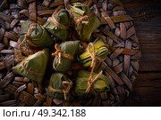 Zongzi Glutinous sticky Rice Dumplings recipe wrap with bamboo leaves asian food. Стоковое фото, агентство Ingram Publishing / Фотобанк Лори