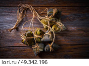 Zongzi Glutinous sticky Rice Dumplings recipe wrap with bamboo leaves asian food. Стоковое фото, агентство Ingram Publishing / Фотобанк Лори