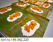Tamale preparation Mexican recipe with banana leaves and cornmeal. Стоковое фото, агентство Ingram Publishing / Фотобанк Лори