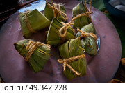 Zongzi Glutinous sticky Rice Dumplings recipe wrap with bamboo leaves asian food. Стоковое фото, агентство Ingram Publishing / Фотобанк Лори
