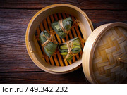 Zongzi Glutinous sticky Rice Dumplings recipe wrap with bamboo leaves asian food. Стоковое фото, агентство Ingram Publishing / Фотобанк Лори