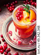 Alcoholic club drink. Sangria with orange,mint and berries in a glass goblet. Стоковое фото, агентство Ingram Publishing / Фотобанк Лори