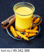 Healthy golden milk. Turmeric Golden milk in a glass cup. Стоковое фото, агентство Ingram Publishing / Фотобанк Лори