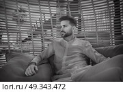 young beard man relaxed in a beach parasol hammock at summer. Стоковое фото, агентство Ingram Publishing / Фотобанк Лори