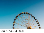Ferris wheel against the blue sky in the port city Gdynia Poland. Стоковое фото, агентство Ingram Publishing / Фотобанк Лори
