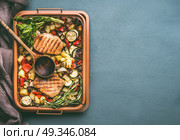 Colorful grilled vegetables and meat in grill grate try with cooking spoon on kitchen table background, top view with copy space. Стоковое фото, агентство Ingram Publishing / Фотобанк Лори