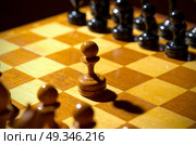 Chessboard with figures on dark background. Стоковое фото, агентство Ingram Publishing / Фотобанк Лори