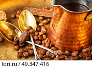 Coffee with sweets. Coffee cezve and beans of Turkish coffee and luxury sweets. Стоковое фото, агентство Ingram Publishing / Фотобанк Лори