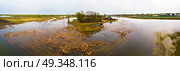 Spring melting river flood aerial panorama. Overflow water at springtime. Drone spate view. Spill landscape.. Spring melting river flood aerial panorama. Overflow water at sp. Стоковое фото, агентство Ingram Publishing / Фотобанк Лори