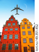 the plane flies low over the Stortorget place in Gamla stan, Stockholm Sweden.. Stortorget place in Gamla stan. Стоковое фото, агентство Ingram Publishing / Фотобанк Лори