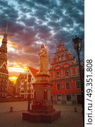 Riga Church of St. Peter and the streets of the ancient city. The red moon is shining.. Riga Church of St. Peter . Стоковое фото, агентство Ingram Publishing / Фотобанк Лори
