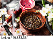 Oriental tobacco hookah with floral jasmine aroma. Smoke hookah with jasmine floral scent.Shisha concept.Modern hookah. Стоковое фото, агентство Ingram Publishing / Фотобанк Лори
