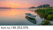 A small boat sits in the water near the shore. Стоковое AI-изображение, AI-художник Ярославский Максим / Фотобанк Лори