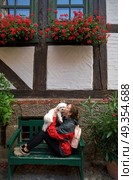 Girl tourist kissing Maltese bichon dog in Germany. Girl tourist kissing Maltese bichon puppy dog in Germany. Стоковое фото, агентство Ingram Publishing / Фотобанк Лори