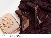 Hight heel shoes for Christmas party. Pair of High heel elegant shoes, golden bag and laced dress. Стоковое фото, агентство Ingram Publishing / Фотобанк Лори