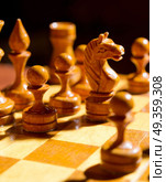 Chessboard with figures on dark background. Chessboard with figures. Стоковое фото, агентство Ingram Publishing / Фотобанк Лори