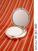 Collapsible mirror on a bright background. Small mirror. Стоковое фото, агентство Ingram Publishing / Фотобанк Лори