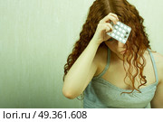 The thoughtful girl holds in a hand of a tablet and reflects on the developed situation. Condition of a hopelessness. Стоковое фото, агентство Ingram Publishing / Фотобанк Лори