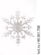 One silvery snowflake on a white background. Winter figures. Стоковое фото, агентство Ingram Publishing / Фотобанк Лори