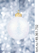 White Christmas-tree decoration on a silvery background. Christmas-tree decoration. Стоковое фото, агентство Ingram Publishing / Фотобанк Лори