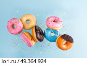 flying doughnuts on blue. Стоковое фото, агентство Ingram Publishing / Фотобанк Лори