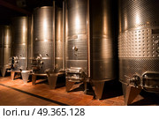 cellar with wine barrels. cellar with modern metal wine barrels rows. Стоковое фото, агентство Ingram Publishing / Фотобанк Лори