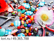 Beads and poppy. Huge collection of women’s trinkets, beads, jewelry, rhinestones and bijouterie. Стоковое фото, агентство Ingram Publishing / Фотобанк Лори