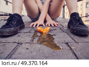 Two ice cream melted on the floor near a young people sit. Стоковое фото, агентство Ingram Publishing / Фотобанк Лори
