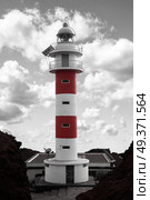 Lighthouse Punta de Teno is Tenerife on the Atlantic Ocean. black and red and white photo. Стоковое фото, агентство Ingram Publishing / Фотобанк Лори